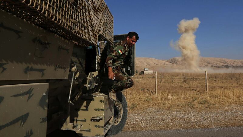 Kurdish Peshmerga fighters detonate a land mine laid by the Islamic State group fighters in the Iraqi town of Bashiqa, some 25km northeast of Mosul. Photograph: Safin Hamed/AFP/Getty Images