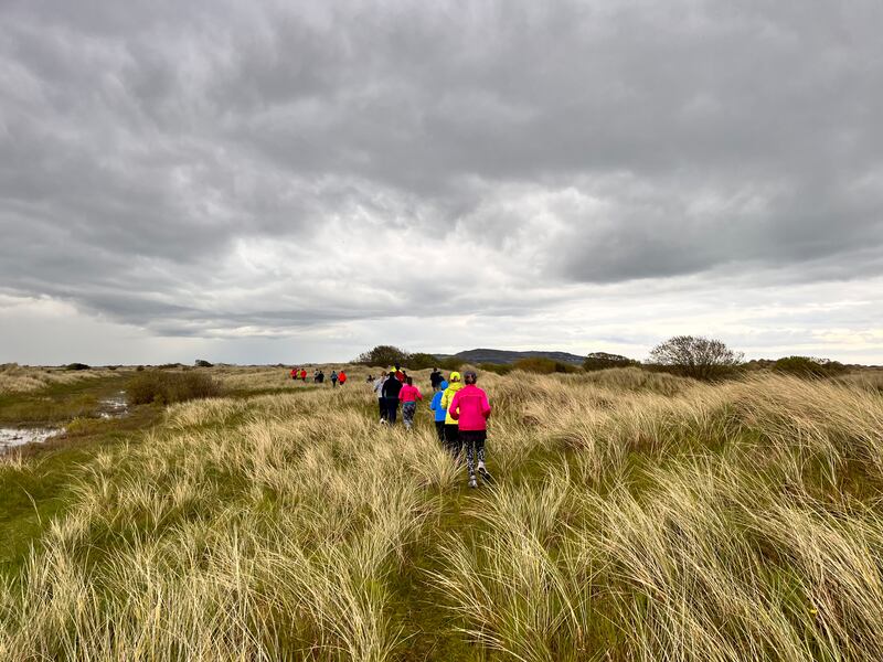 Members of ForgetTheGym explore the sand dunes at Dollymount.