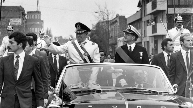 General Augusto Pinochet (left), head of the Chilean military junta, waves from the motorcade 11 September 1973 in Santiago, shortly after his coup d’etat that killed socialist President Salvador Allende. Photograph:  STR/AFP/Getty Images