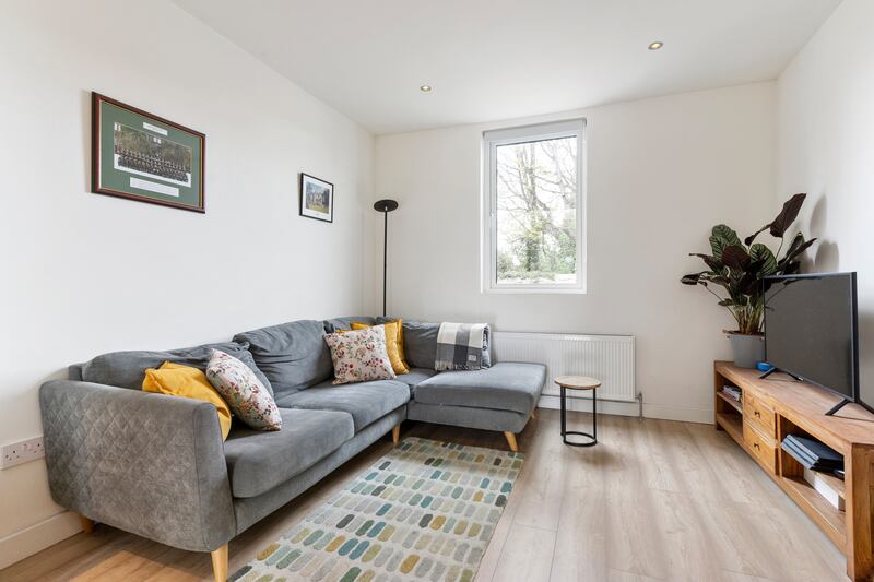 The owners had a wall knocked between two reception rooms to the front of the house to create one cohesive living space