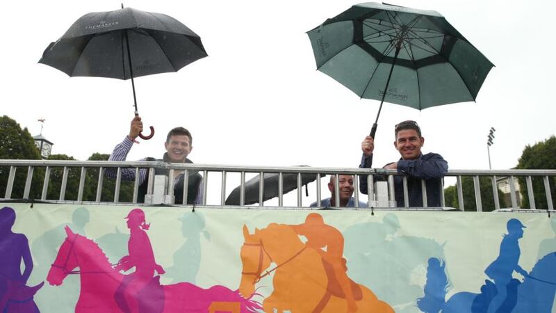 Spectators shelter from the rain at the 2015 Dublin Horse Show at the RDS, Dublin. Photograph: Brian Lawless/PA Wire
