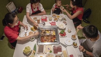Diners at a Haidilao restaurant: hot pot, in which diners cook their own meat and vegetables in a boiling broth, is a favourite meal in China. Photograph: Gilles Sabrié/ The New York Times