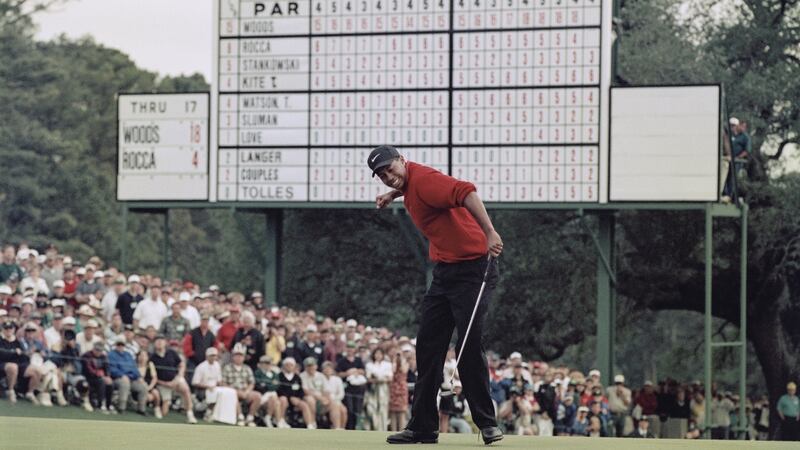 Tiger Woods  celebrates after sinking a putt to win the  Masters in 1997 in a record  low score of 18 under par. Photograph:  Stephen Munday/Allsport/Getty Images