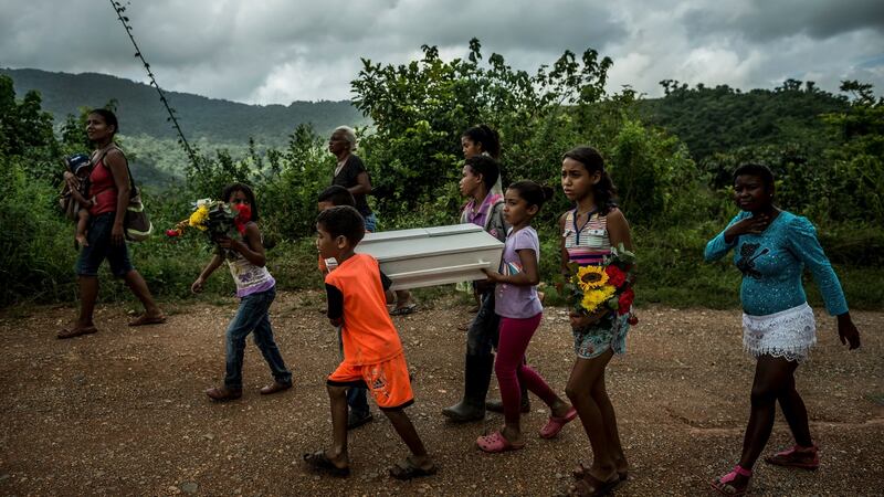 Children carry the coffin of three-month-old Kleiver Enrique Hernández, to the cemetery from his home in Urdaneta, Venezuela. Photograph: Meridith Kohut/The New York Times
