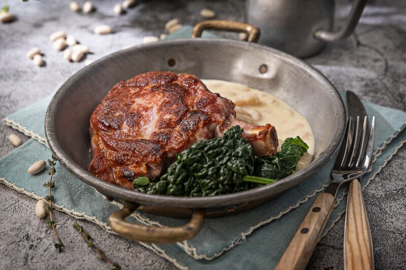 Grilled bacon chop, Parmesan creamed cannellini beans. Photograph: Harry Weir Photography