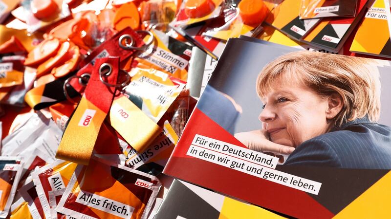 German chancellor Angela Merkel on brochures and election paraphernalia. Photograph: Felipe Trueba/EPA