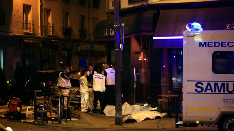 Medics stand by victims in a Paris restaurant, on Friday, November 13th, 2015. Photograph: Thibault Camus/File/AP Photo