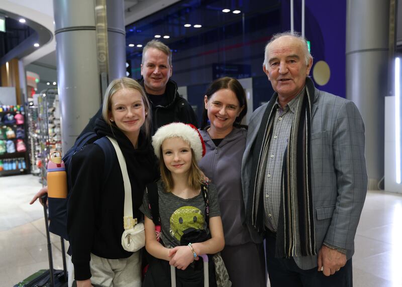 Murt Coleman (right) greets his daughter Deirbhle, her husband Peter Newhall and their daughters Saibh (11) and Freya (16) from the US at the airport. Photograph: Bryan O’Brien/The Irish Times

