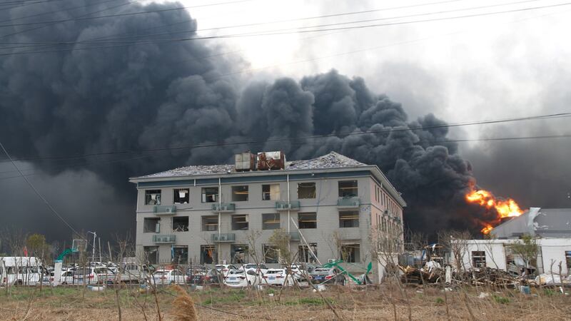 Smoke billows from fire behind a damaged building following an explosion at the pesticide plant. Photograph: Reuters/Stringer