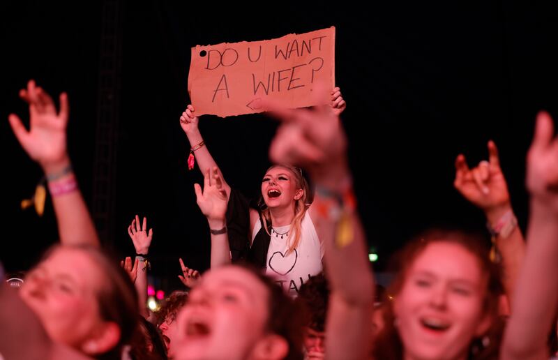 An offer from a fan as Elijah Hewson of the band Inhaler plays the Electric Arena stage  on Saturday. Photograph: Alan Betson/The Irish Times

