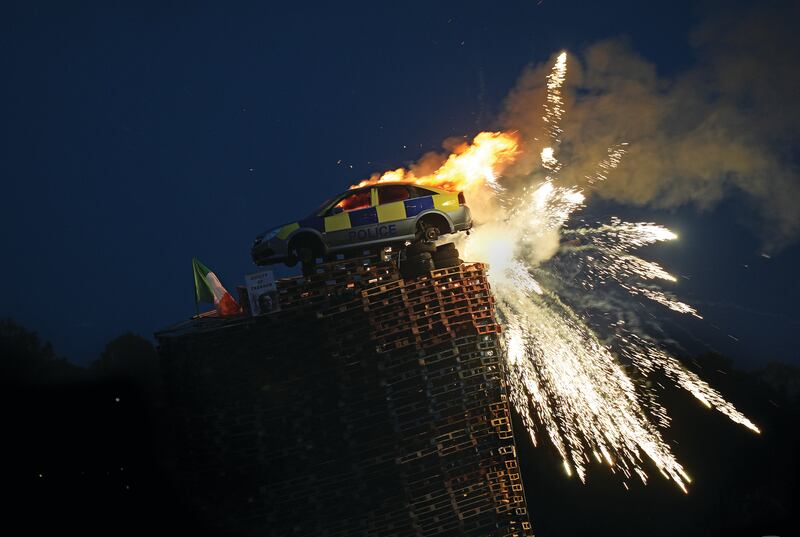 TOWERING INFERNO: A mock police car is set alight at an Eleventh Night bonfire in Moygashel, Co. Tyrone. Photograph: Niall Carson  / PA Media