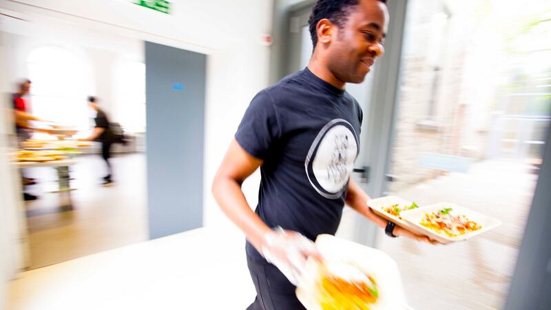 A member of the Sligo Global Kitchen getting the food out during the  first supper club at the Model Arts Centre. Photograph: Brian Farrell