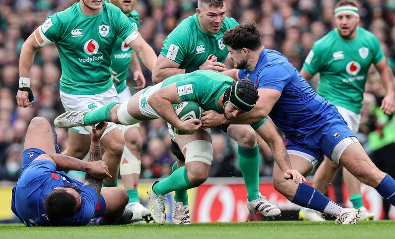 Monster in the loose: Uini Atonio reaches for the foot of Caelan Doris's foot as the Irish player ploughs into Julien Marchand. Photogoraph: Billy Stickland/Inpho