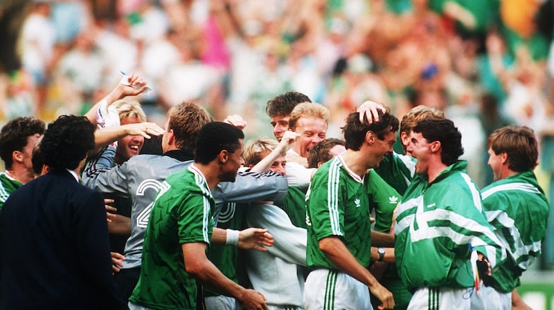 David O’Leary is congratulated by his Ireland team-mates after converting the winning penalty against Romania. Photograph: Billy Stickland/Inpho