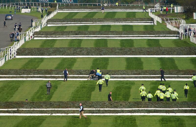 Police officers respond to Animal Rising activists attempting to invade the racecourse ahead of April's Grand National at Aintree. 