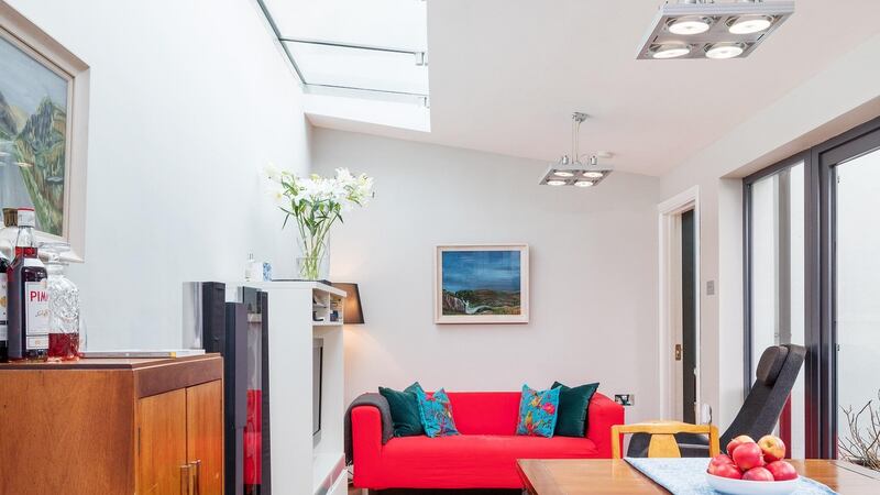 The dining room has solid walnut herringbone parquet which adds warmth to the otherwise white space.