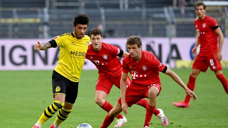 Thomas Muller tries to press Jadon Sancho during Bayern’s narrow win over Dormund. Photograph: Federico Gambarini/Getty/AFP