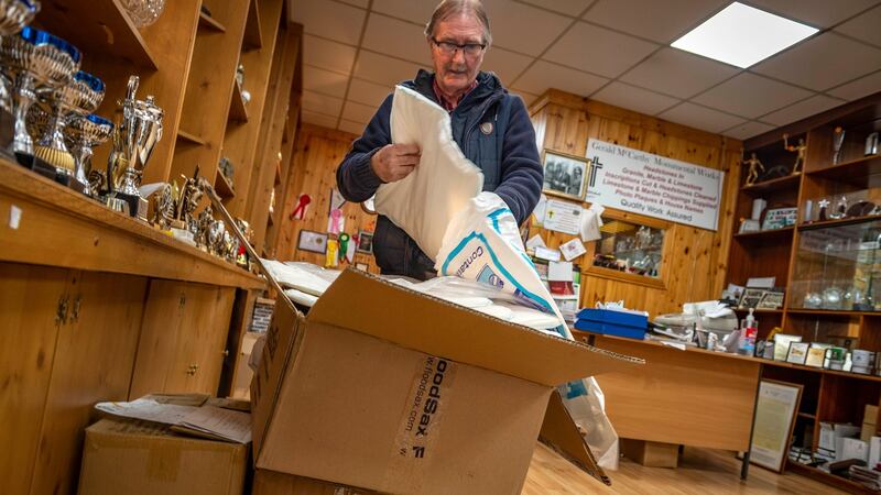 Former Cork hurler Gerald McCarthy making flood preparations in his shop on Princes Street, Cork. Photograph: Michael Mac Sweeney/Provision