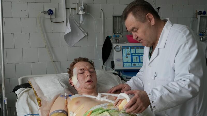 A medical worker attends to a wounded man at a hospital in Brovary, outside Kyiv. Photograph: Efrem Lukatsky/AP