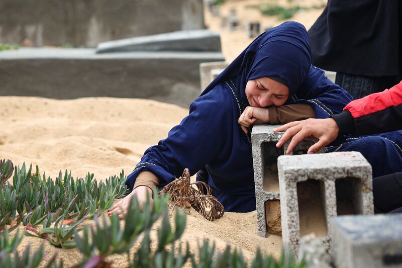 A woman cries over the grave of a loved one at the start of the Eid al-Fitr festival in Rafah, Gaza, on Wednesday. Photograph: AFP via Getty