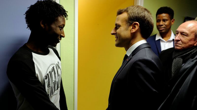 French president Emmanuel Macron shakes hands with Ahmed Adam from Sudan during his visit to a migrant centre in Croisilles, near Calais. Photograph: Michel Spingler/Reuters