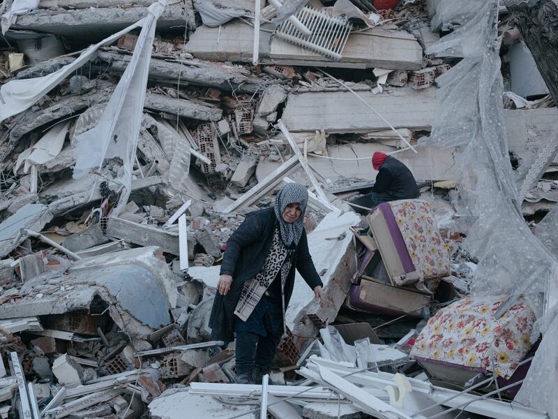 A mother searches for her son amidst the rubble of collapsed buildings in Kahramanmaras, Turkey. Photograph: Emin Ozmen/New York Times