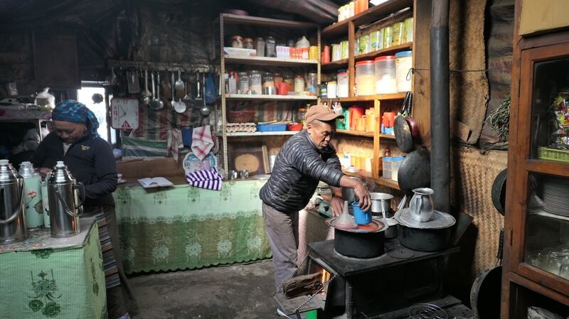 Ang Phurba Sherpa working in the kitchen of his lodge in Marulung.