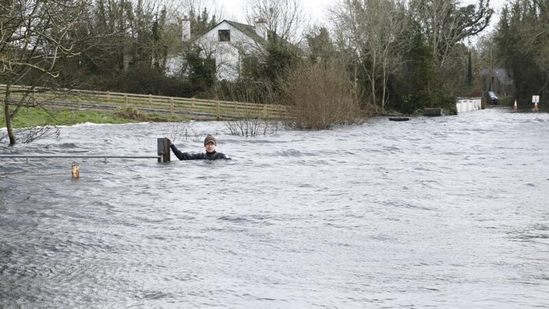 Up to his neck: Brian Keogh in the floodwater by his house, in Ballycar; the flooded sections are up to 350m long. Photograph: Liam Burke/Press 22
