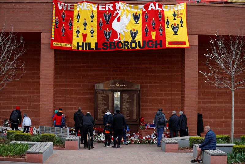 Members of the public pay their respects at the memorial. Photograph: Phil Noble/Reuters