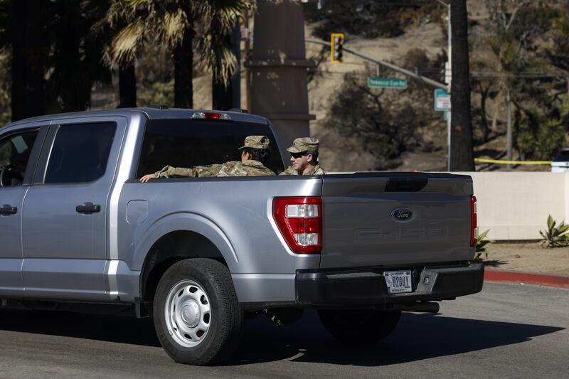 A National Guard vehicle drives through the Pacific Palisades neighbourhood. Photograph: Caroline Brehman/EPA-EFE