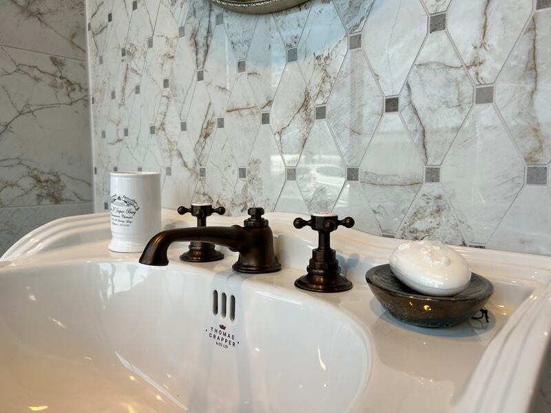 A matte black finish on fittings adds a contemporary touch to classic bathroom fixtures: Swadling Brassware Invincible basin taps in Aged Brass, matki.co.uk