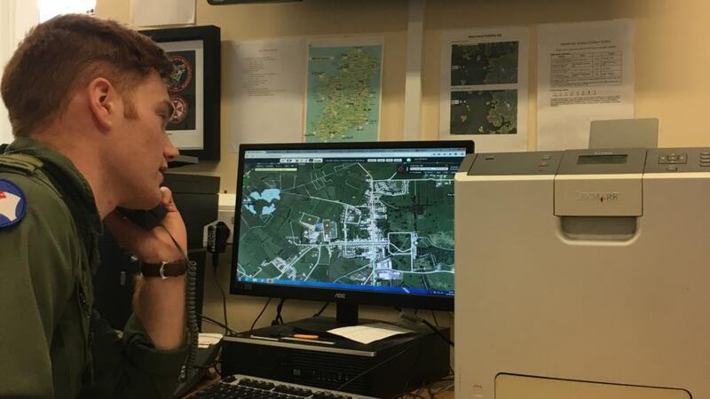 Lt Kevin Fitzgerald searches the Health Atlas for a suitable landing site and its map co-ordinates. Photograph: Peter Murtagh
