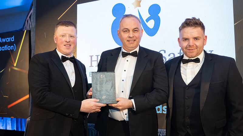 Emmet Cosgrove, chief executive of O'Reilly Group, presents the health & safety excellence award – construction (large organisation) to Kenneth Lambe and Noel Galligan, Ardmac