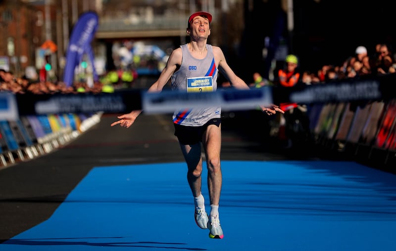 Killian Mooney crosses the finish line to win the men’s race. Photograph: Ryan Byrne/Inpho