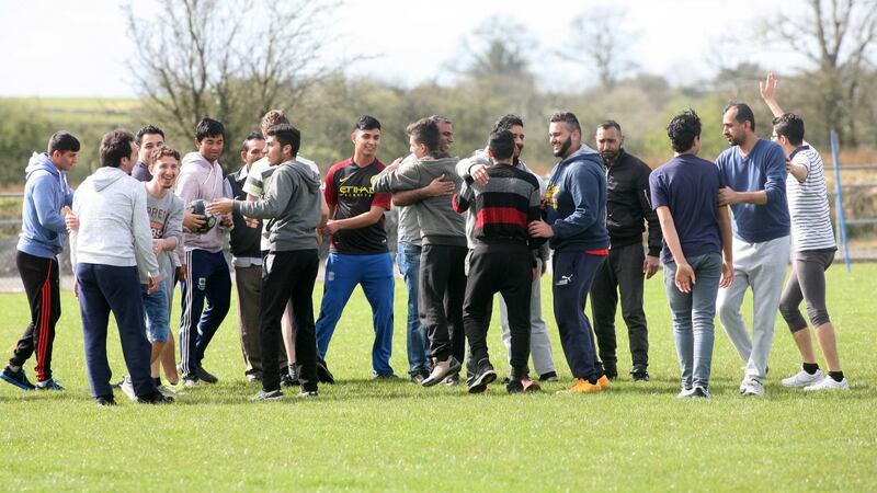 Syrian refugees and members of the Pakistani community in Ballaghaderreen take part in a 10-a-side soccer match at the local community playground on Saturday. Above, players greet each other before the game. Photograph: Brian Farrell