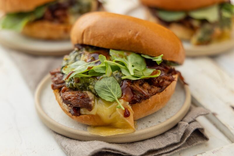 Pulled pork sandwich with barbecue sauce and chimichurri. Photograph: Harry Weir Photography