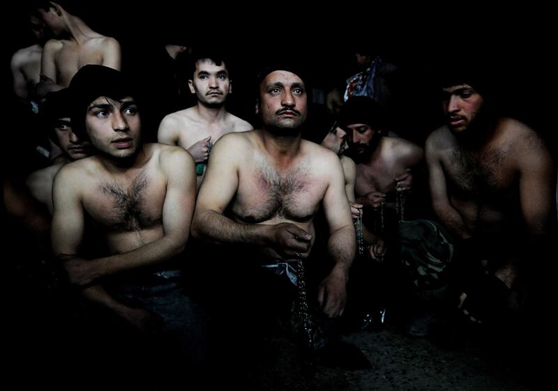 January 15th, 2008: Afghan men hold chains as they wait to take part in ritual self-flagellation to celebrate the Muslim festival of Ashura, at a mosque in Kabul. Photograph: Shah Marai/AFP