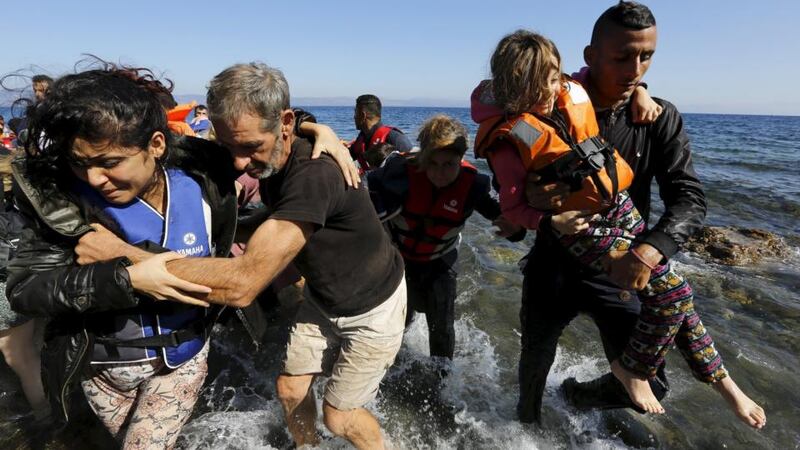 Syrian refugees arrive on a dinghy at a beach on the Greek island of Lesbos after crossing a part of the Aegean Sea from Turkey. Photograph: Yannis Behrakis/Reuters