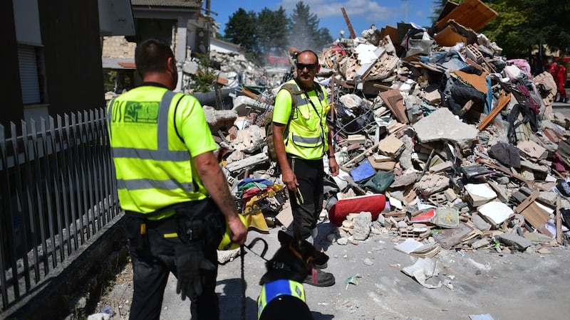 Emergency workers continue on Thursday to search buildings  destroyed during an earthquake  in Amatrice, Italy. Photograph: Carl Court/Getty Images