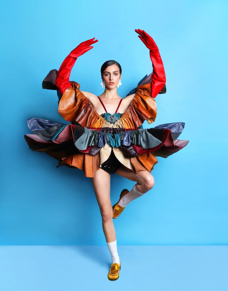 Sculptural leather dress by Siobhan Curtis, @siobhancurtis; red leather gloves by Izabela Z via Zeda the Architect, @izabela_z_dublin, @notzeda; white floral earrings by Kybalion Jewellery via The Collective; saffron satin loaders by Tela via Beautiful South, @tela09official@beautiful.south