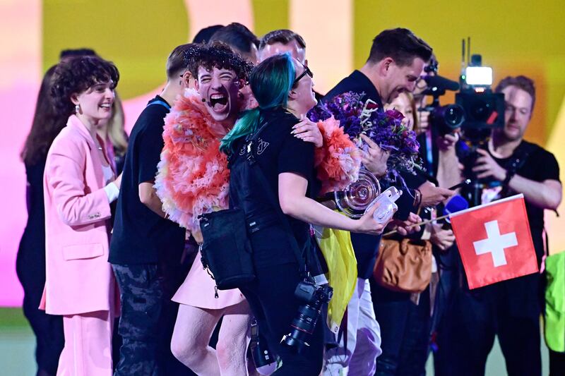 Winner Swiss singer Nemo reacts with a crew member after breaking the Eurovision trophy. Photograph: TOBIAS SCHWARZ/AFP via Getty Images