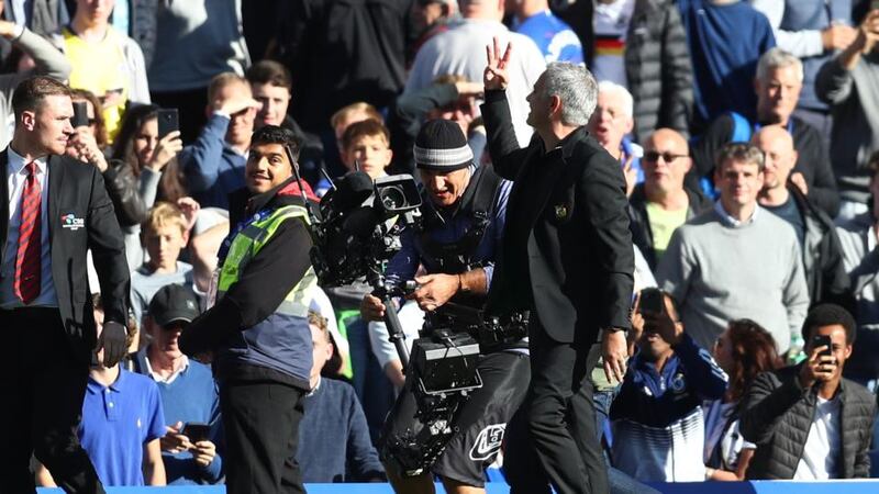 Mourinho holds three fingers up to the Chelsea crowd. Photo: Clive Rose/Getty Images