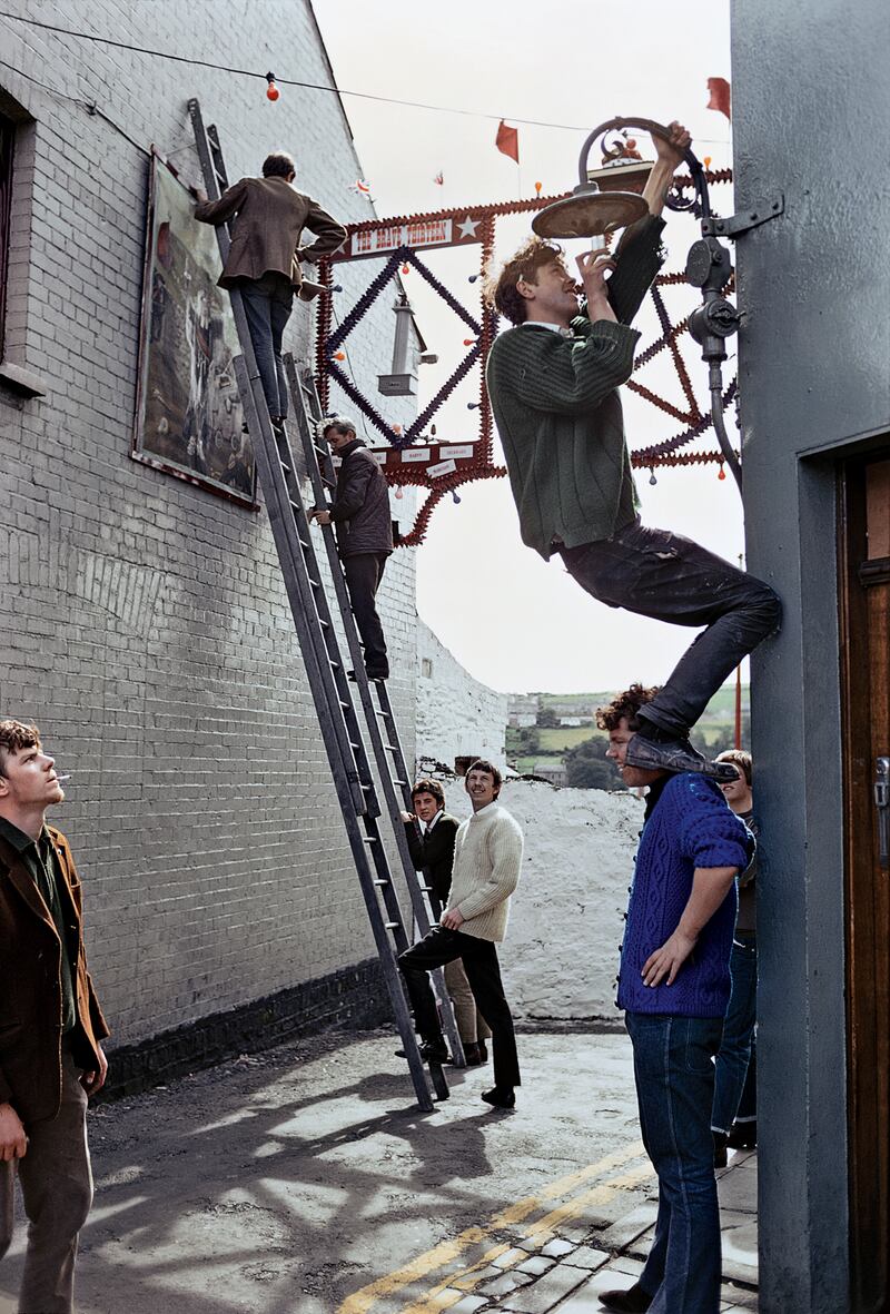 Men work on the preparations for the Twelfth of July celebrations in the Fountain area of Derry in 1969.