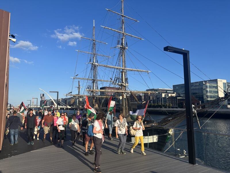 Walkers pass the Jeanie Johnston replica famine ship. Photograph: Sorcha Pollak