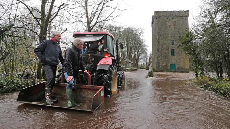 Colm Farrell and Cllr Joe Byrne survey flooding at the Yeats Tower near Gort, Co Galway on Sunday. A  clean-up is under way across many parts of the country on Monday after Storm Desmond caused widespread flooding.  Photograph: Joe O’Shaughnessy
