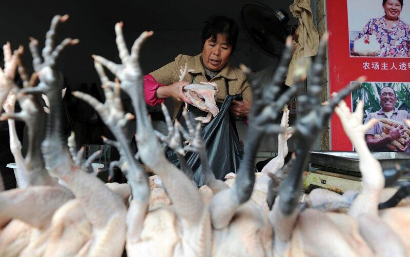 A vendor puts chickens into a plastic bag at a poultry market in Hefei, Anhui province, today. Chinese authorities reported four new cases  of a strain of bird flu previously unknown in humans that has already killed two people. Photograph: Reuters
