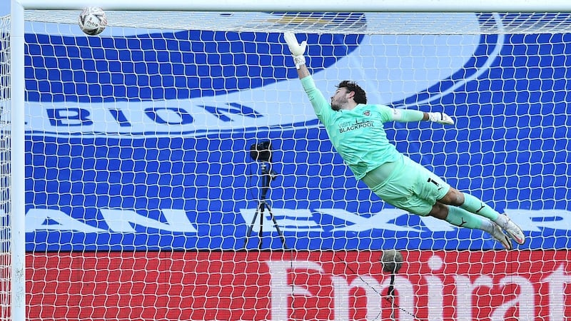 Blackpool goalkeeper Chris Maxwell can’t stop  Yves Bissouma’s strike. Photograph: Glyn Kirk/Getty/AFP