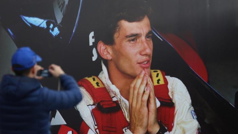 A man takes a picture of a poster of late Brazilian Formula 1 legend Ayrton Senna at the Imola race track. Photograph: Giorgio Benvenuti/EPA