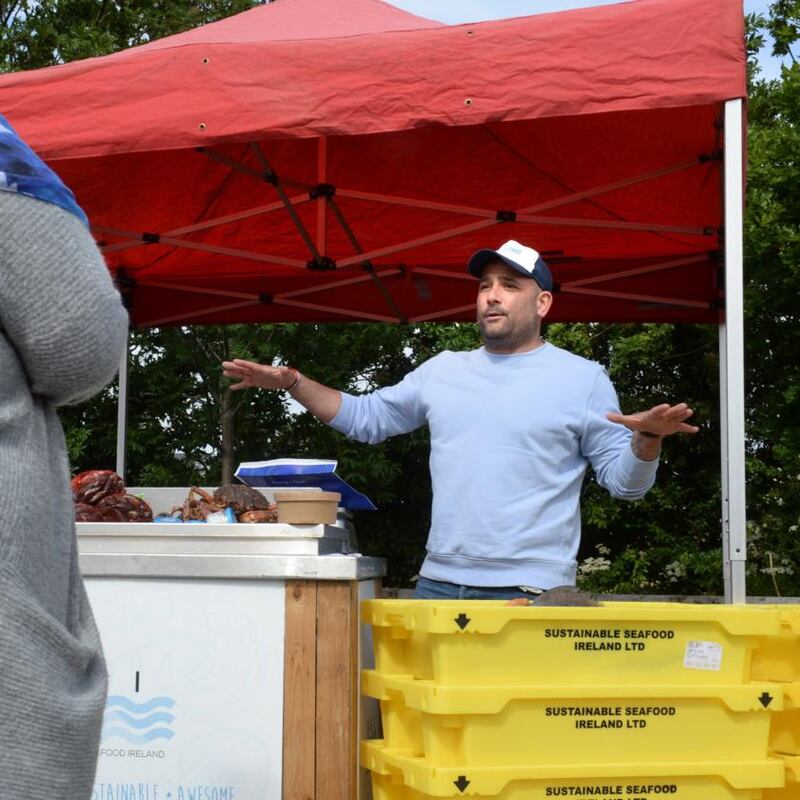 Niall Sabongi from Sustainable Seafood Ireland talking to customers at his stall. Photograph: Dara Mac Dónaill/The Irish Times