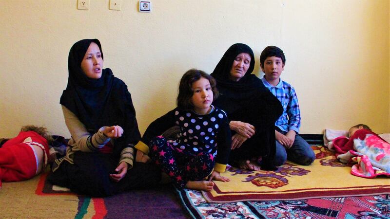 Hakima (left), her mother-in-law Hawa, and children in their bare apartment in Van, Turkey